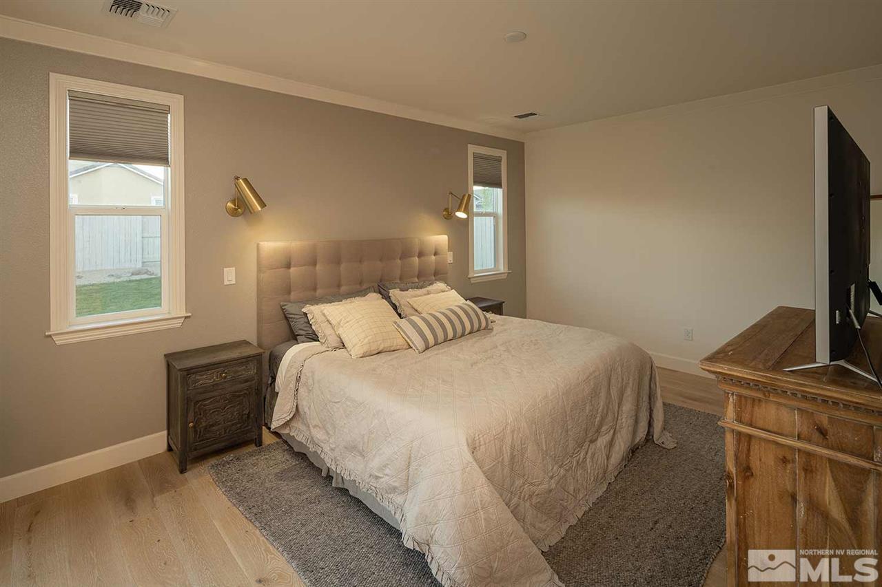 9523 Tencendur Lane Reno, NV 89521 - Photo 17 of 40 a bedroom with a bed and flat tv screen on the dresser