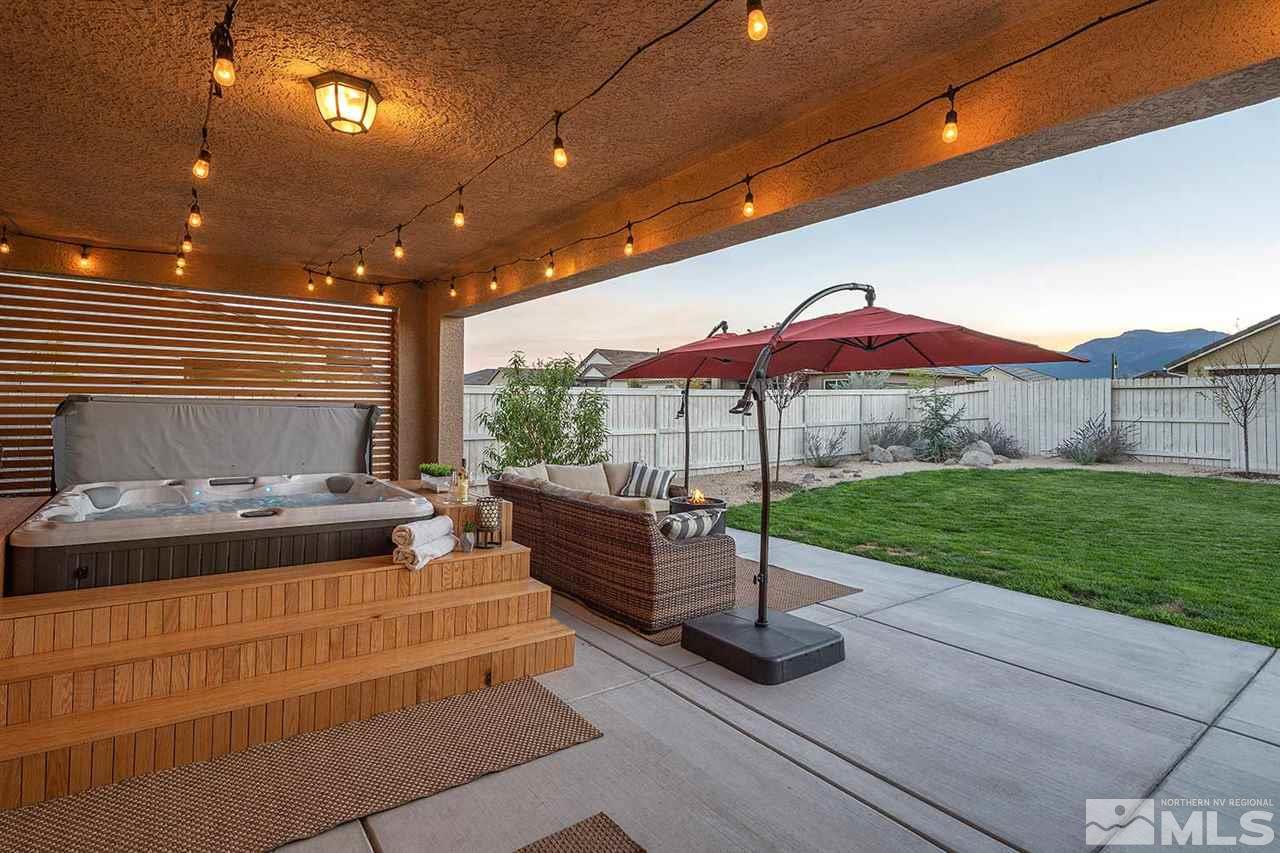 9523 Tencendur Lane Reno, NV 89521 - Photo 32 of 40 a view of a patio with a table and chairs under an umbrella