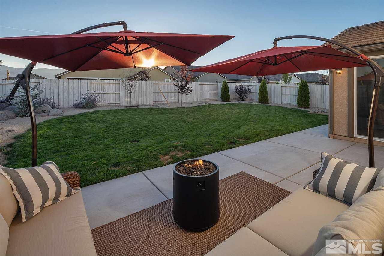 9523 Tencendur Lane Reno, NV 89521 - Photo 35 of 40 a patio with a table and chairs under an umbrella