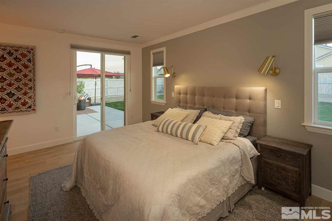 9523 Tencendur Lane Reno, NV 89521 - Photo 5 of 40 a large bed in a bedroom next to a window