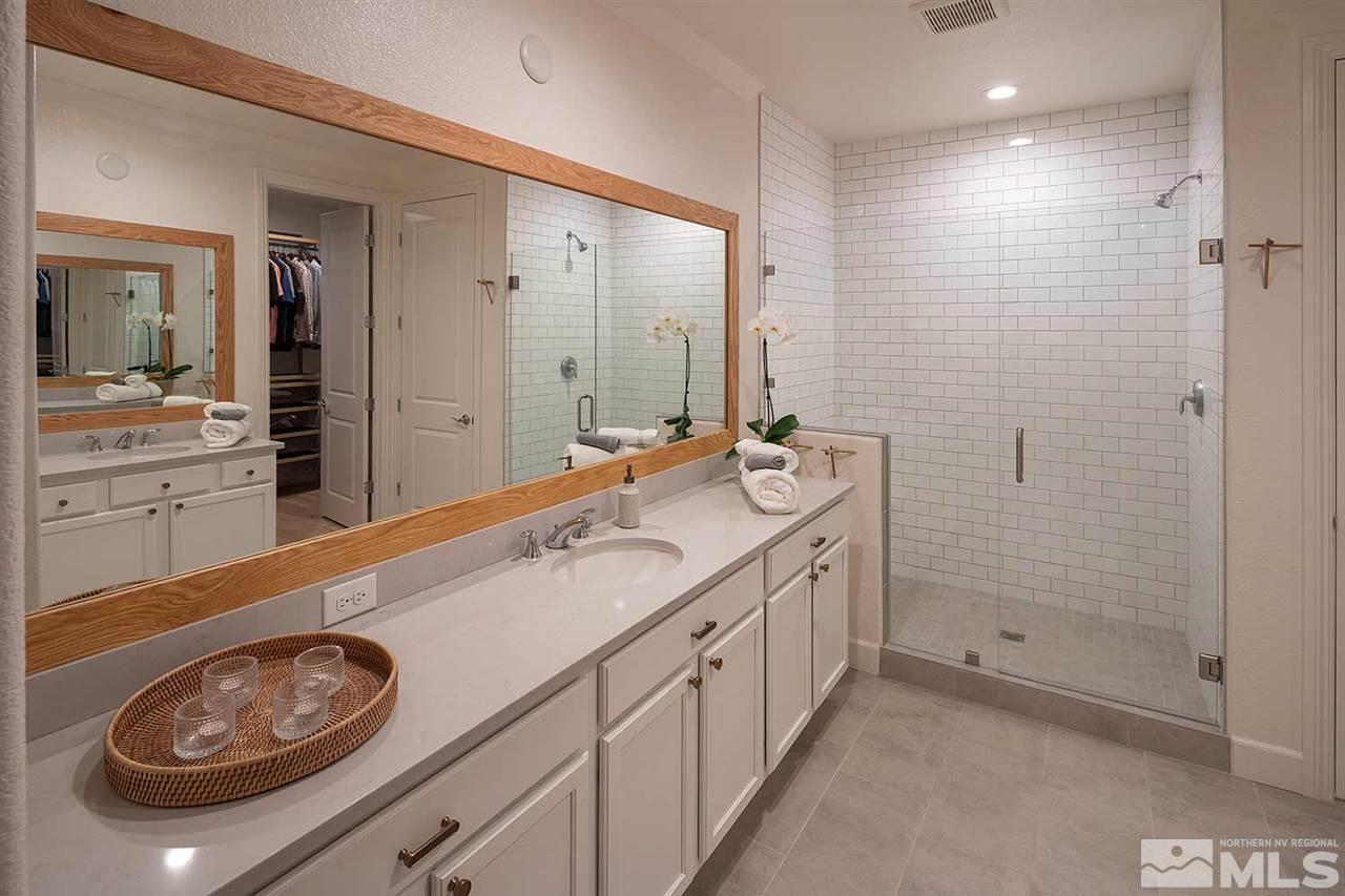 9523 Tencendur Lane Reno, NV 89521 - Photo 6 of 40 a spacious bathroom with a double vanity sink a mirror and a shower