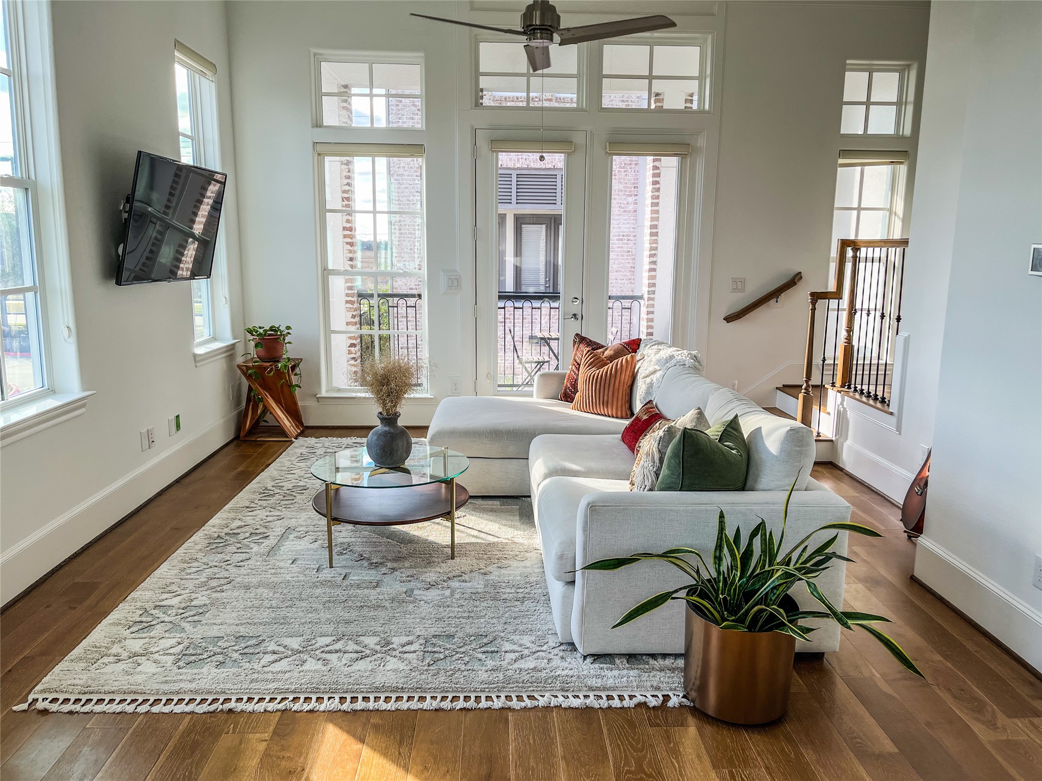 2024 Waterloo Station Road Houston, TX 77045 - Photo 4 of 14 The Living Room has 12 foot soaring ceilings, plenty of windows that flood the room with natural light, recessed lighting, hardwood floors & crown molding highlighting this area.