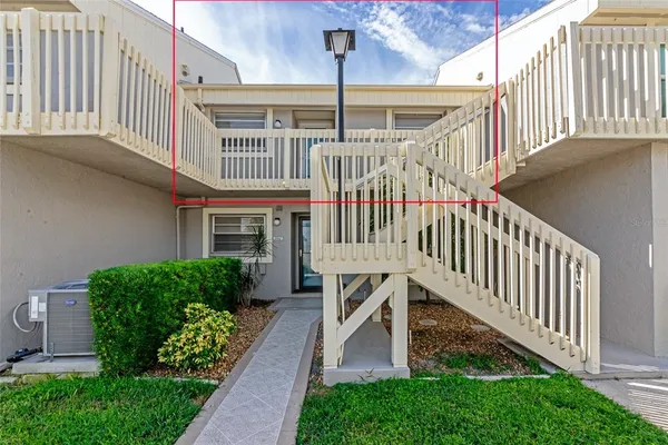 a view of a house with wooden deck and a yard