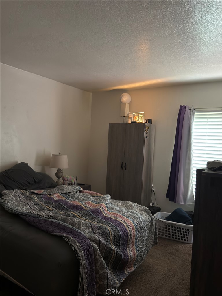 1340 West Lambert Road, Unit 85 La Habra, CA 90631 - Photo 13 of 17 a bedroom with a bed and a flat tv screen