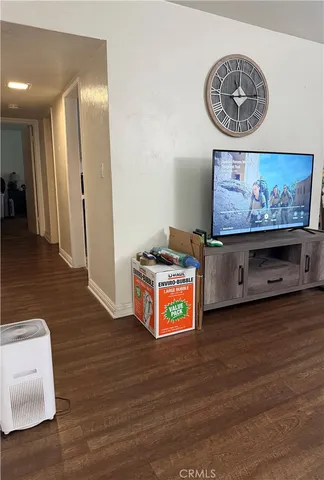 a view of a hallway with wooden floor and a workspace