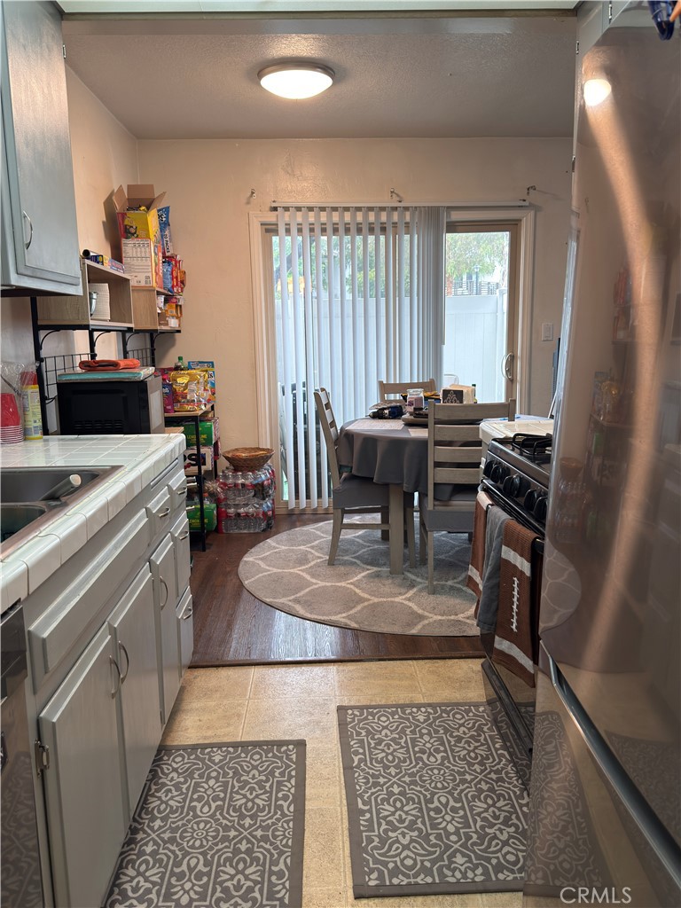 1340 West Lambert Road, Unit 85 La Habra, CA 90631 - Photo 6 of 17 a kitchen with a stove and a refrigerator