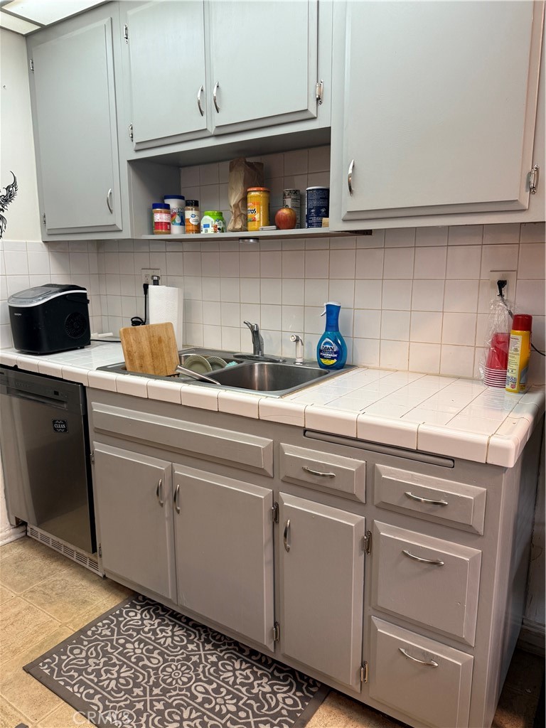 1340 West Lambert Road, Unit 85 La Habra, CA 90631 - Photo 7 of 17 a kitchen with stainless steel appliances granite countertop a sink and cabinets
