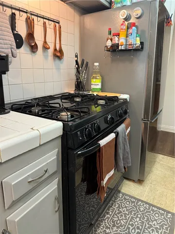 a stove top oven sitting inside of a kitchen