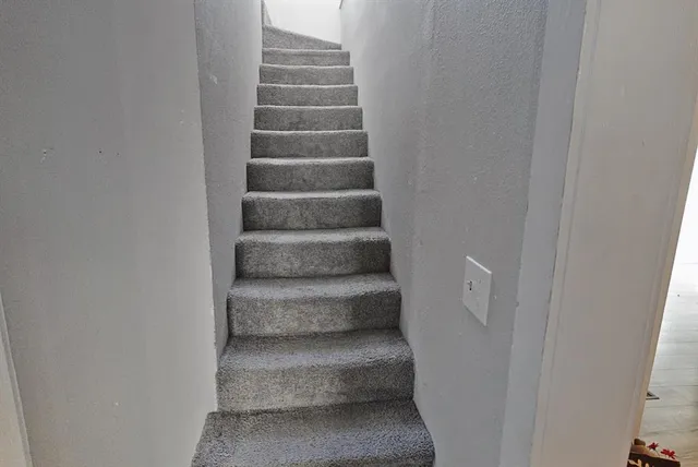 a view of staircase with white walls
