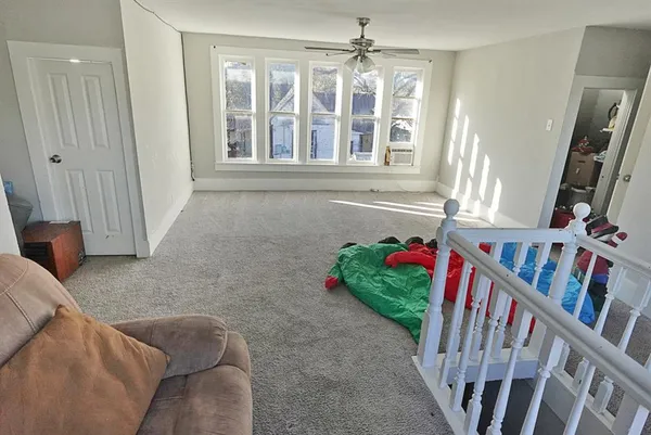 a living room with lots of furniture and a window