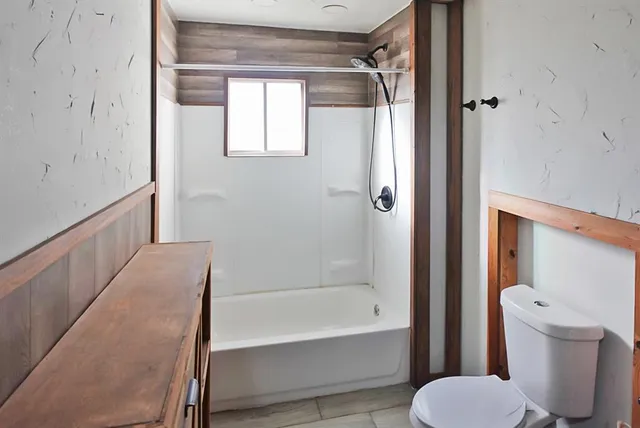 a bathroom with a tub and toilet
