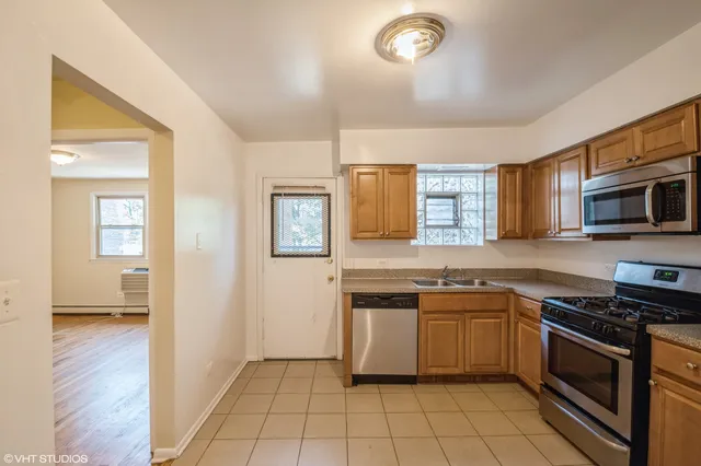 a kitchen with stainless steel appliances a stove sink and microwave