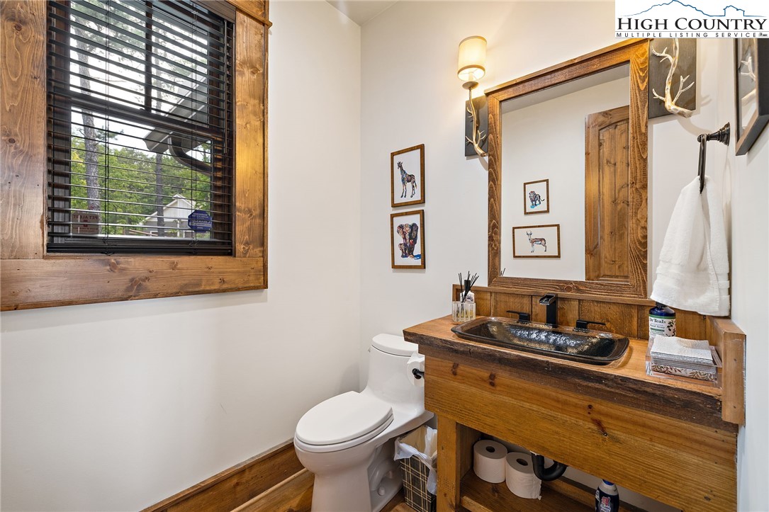 559 Marigold Road Boone, NC 28607 - Photo 21 of 46 a bathroom with a toilet sink and mirror