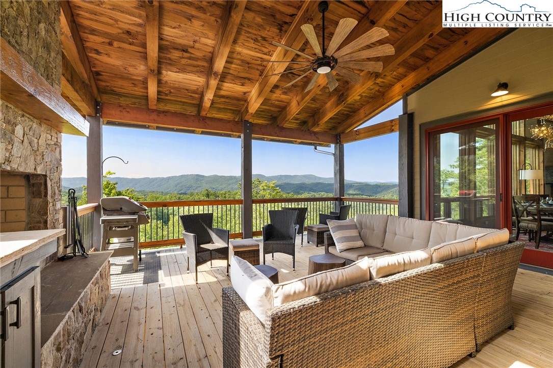 559 Marigold Road Boone, NC 28607 - Photo 22 of 46 a living room with furniture tv large windows and view of outdoor space