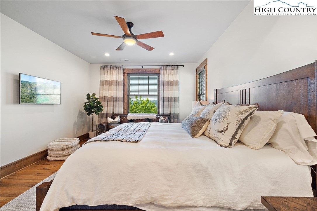 559 Marigold Road Boone, NC 28607 - Photo 29 of 46 a bedroom with a large bed and a chandelier