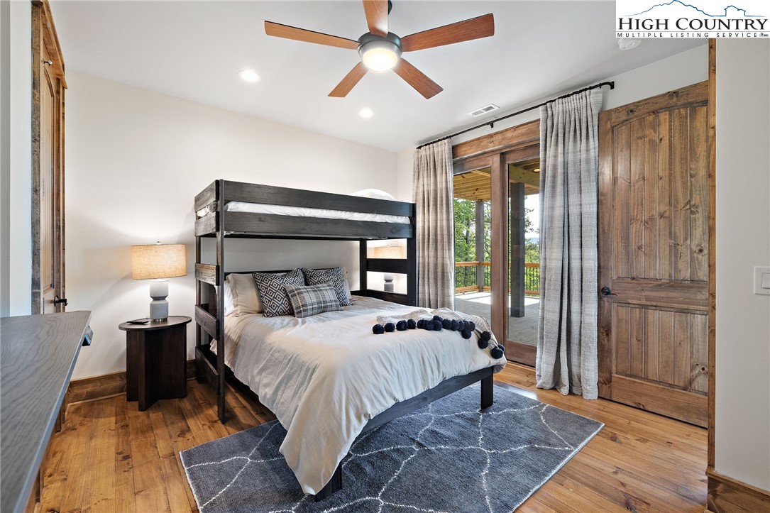 559 Marigold Road Boone, NC 28607 - Photo 31 of 46 a bedroom with a large bed and a chandelier