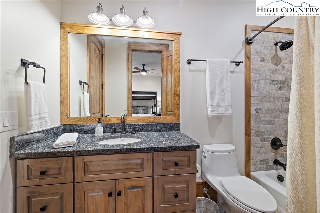 559 Marigold Road Boone, NC 28607 - Photo 32 of 46 a bathroom with a granite countertop sink toilet and shower