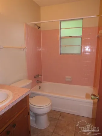 a bathroom with a granite countertop toilet a sink and bathtub