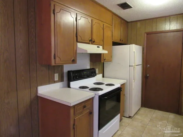 a kitchen with a refrigerator and a sink