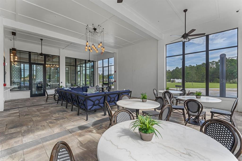 3002 House Finch Road St. Cloud, FL 34773 - Photo 21 of 38 a outdoor dining room with furniture a chandelier and window