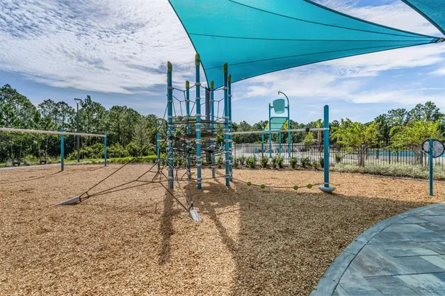 a view of a park with iron fence