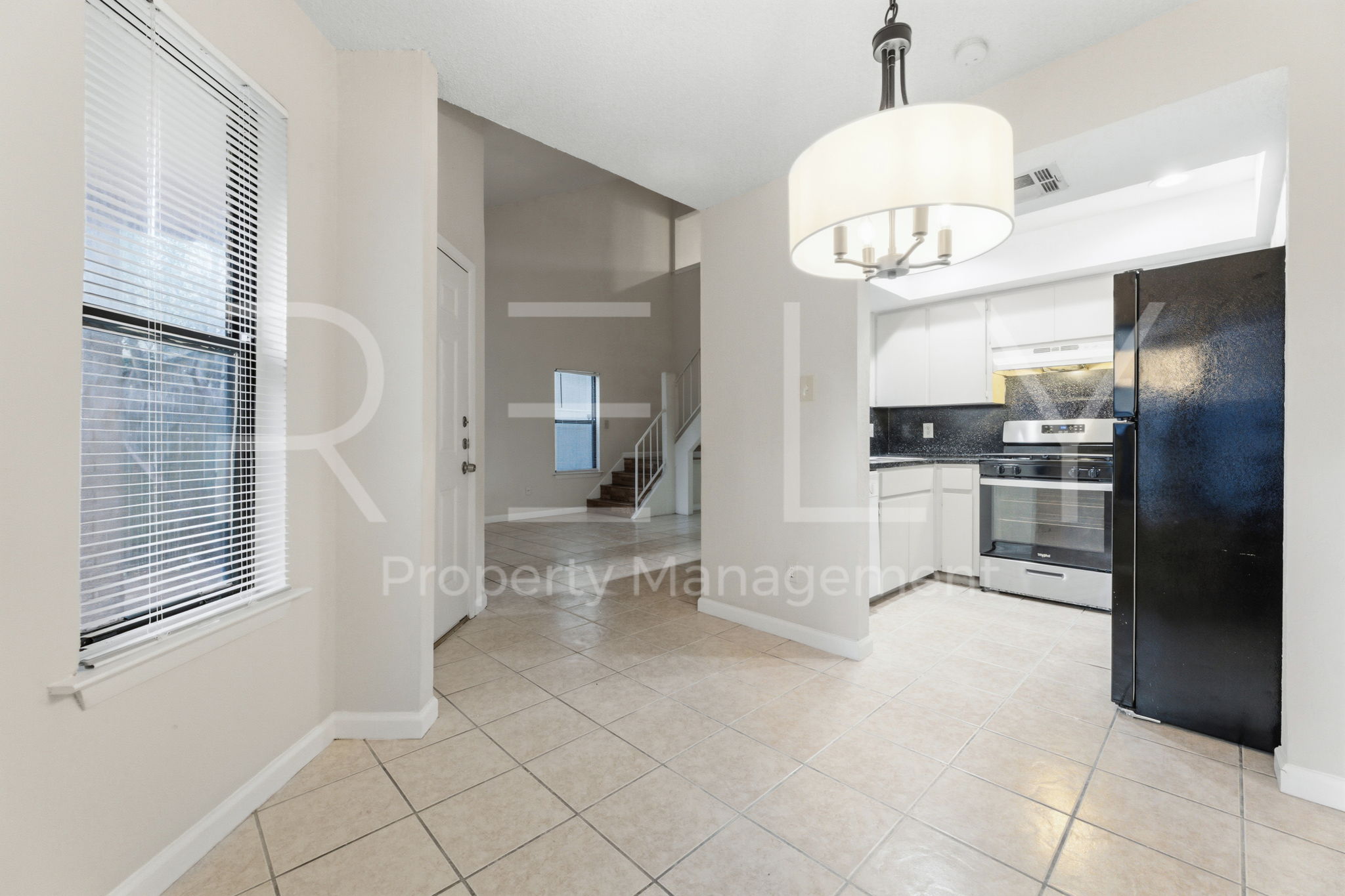 1005 Milford Way, Unit A Austin, TX 78745 - Photo 10 of 30 a view of a kitchen with a sink and refrigerator