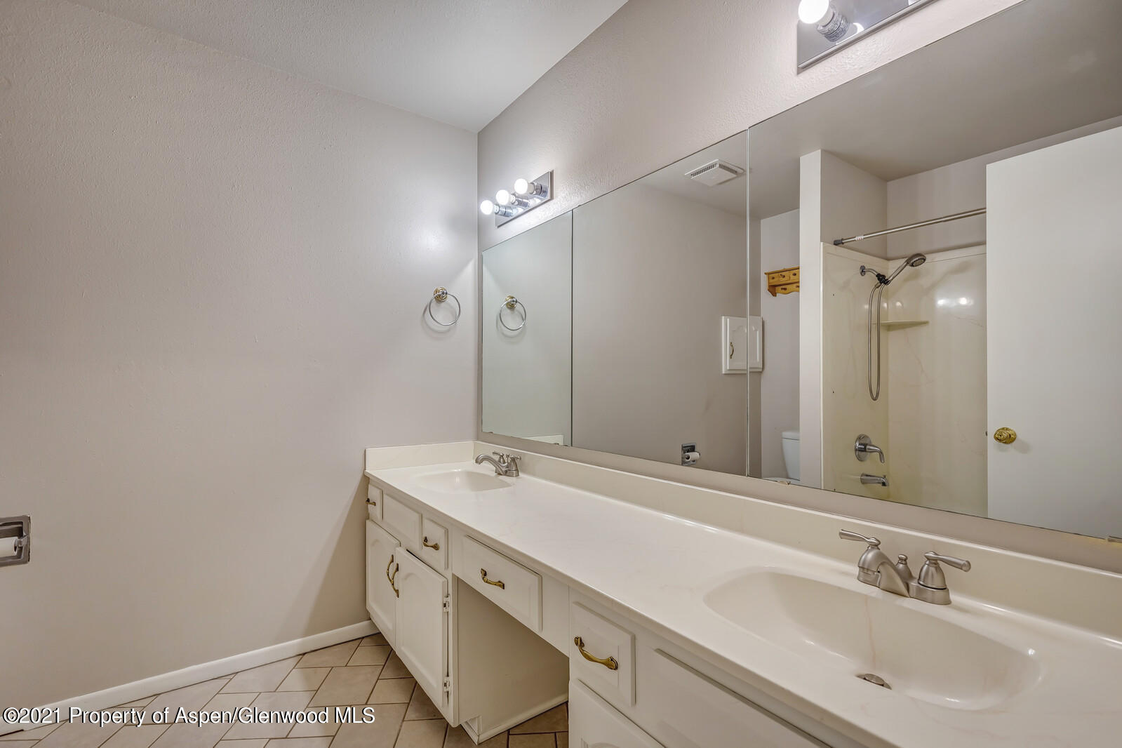 783 Buckeye Court Rifle, CO 81650 - Photo 17 of 27 a spacious bathroom with a shower sink and mirror