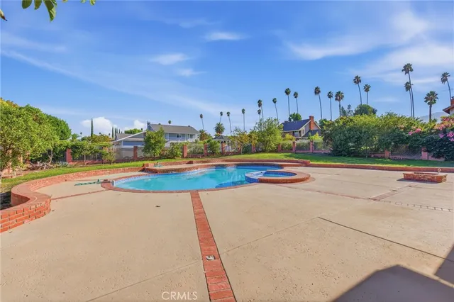 a view of a swimming pool with a yard