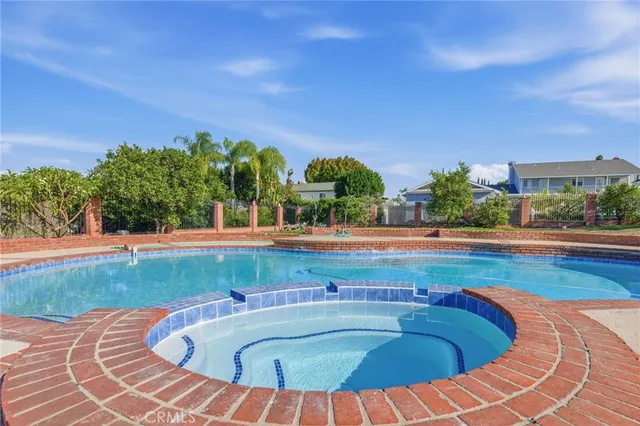 a view of swimming pool with outdoor seating and plants