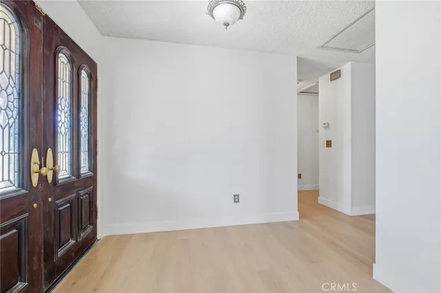 a view of an empty room and fire place