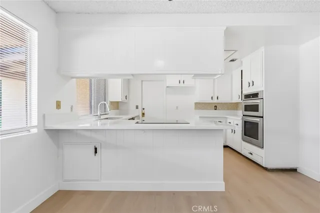 a kitchen with a stove a refrigerator and a sink