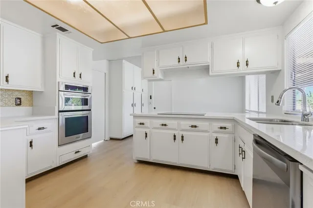 a view of white cabinets and sink