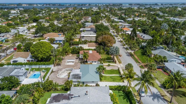 an aerial view of residential houses with outdoor space and street view
