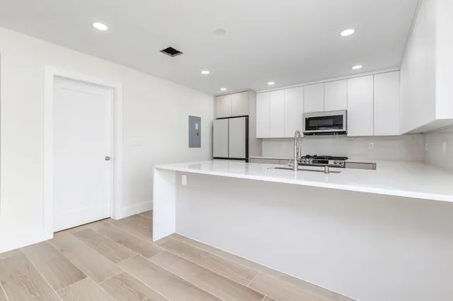 a kitchen with stainless steel appliances refrigerator sink microwave and stove