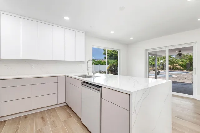 a kitchen with a sink cabinets and window
