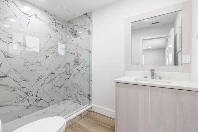 a bathroom with a sink toilet and shower