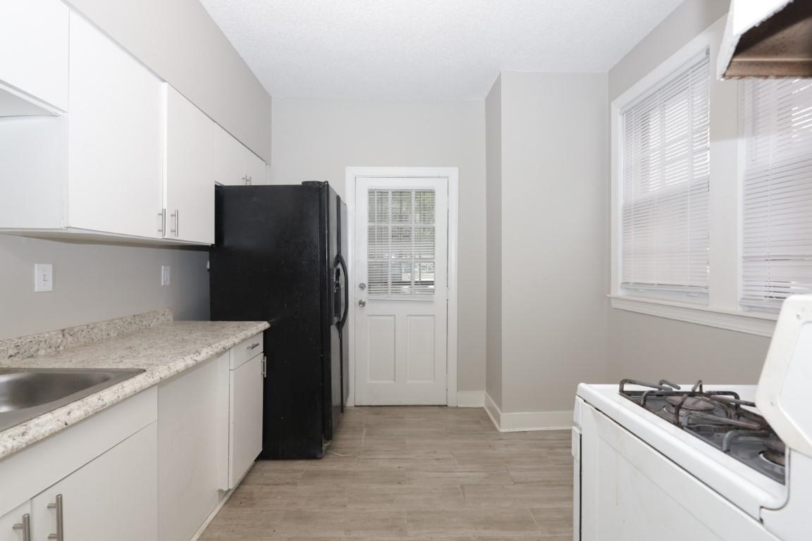 2367 Forrest Avenue, Unit 1 Memphis, TN 38112 - Photo 2 of 9 a kitchen with a refrigerator and a sink