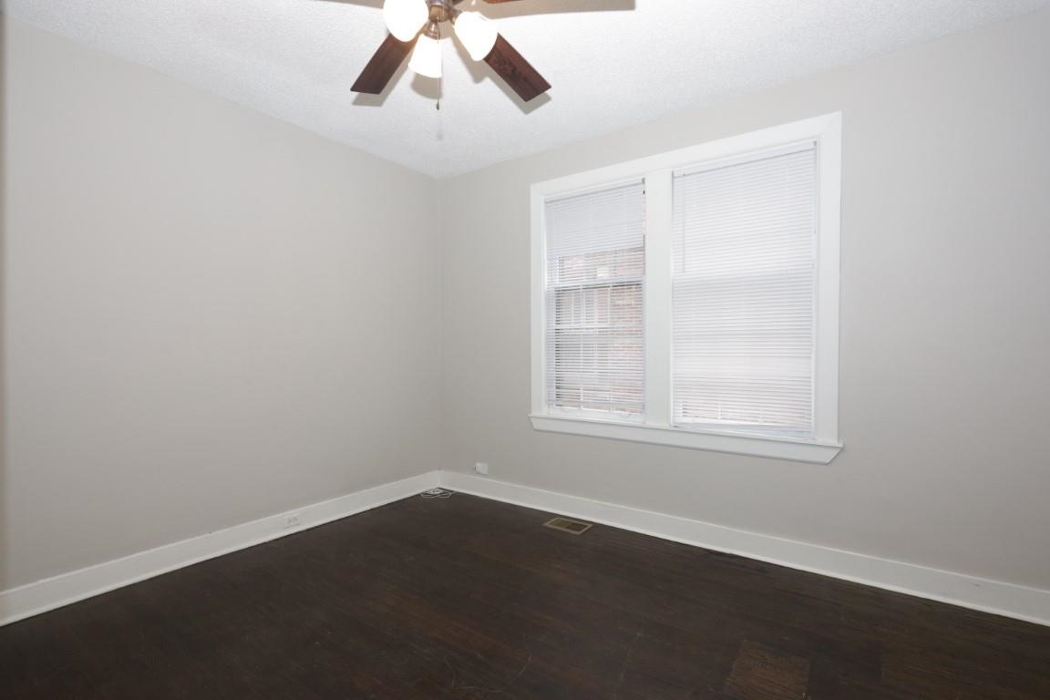2367 Forrest Avenue, Unit 1 Memphis, TN 38112 - Photo 8 of 9 an empty room with wooden floor cabinet and windows