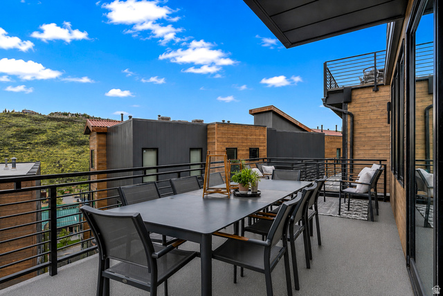 1258 Rothwell Road Park City, UT 84060 - Photo 30 of 48 Expansive outdoor deck featuring a gray surface, black metal railings, and a partial awning