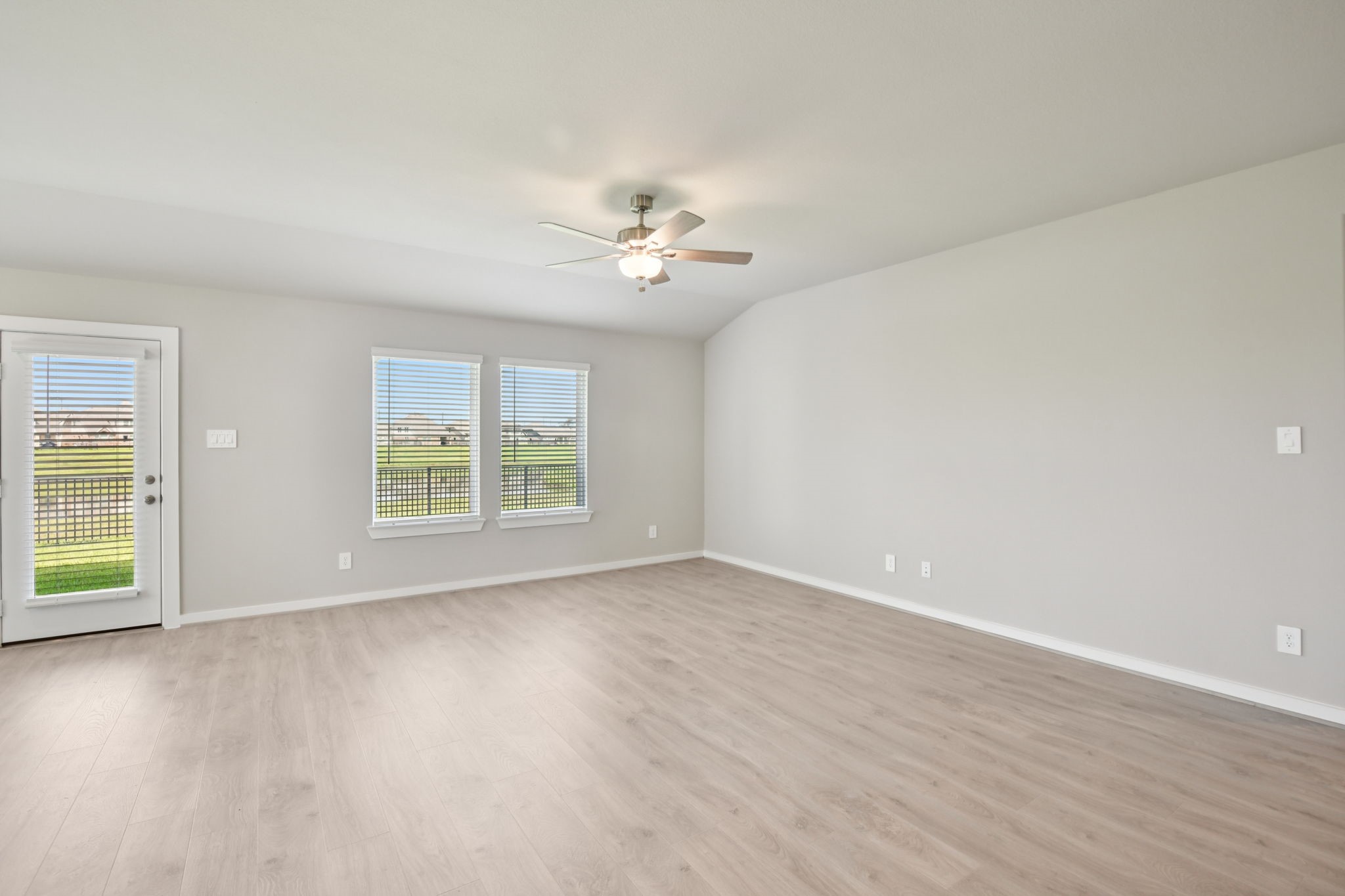 1672 Hopson Ranch Drive Conroe, TX 77301 - Photo 12 of 44 an empty room with wooden floor and windows