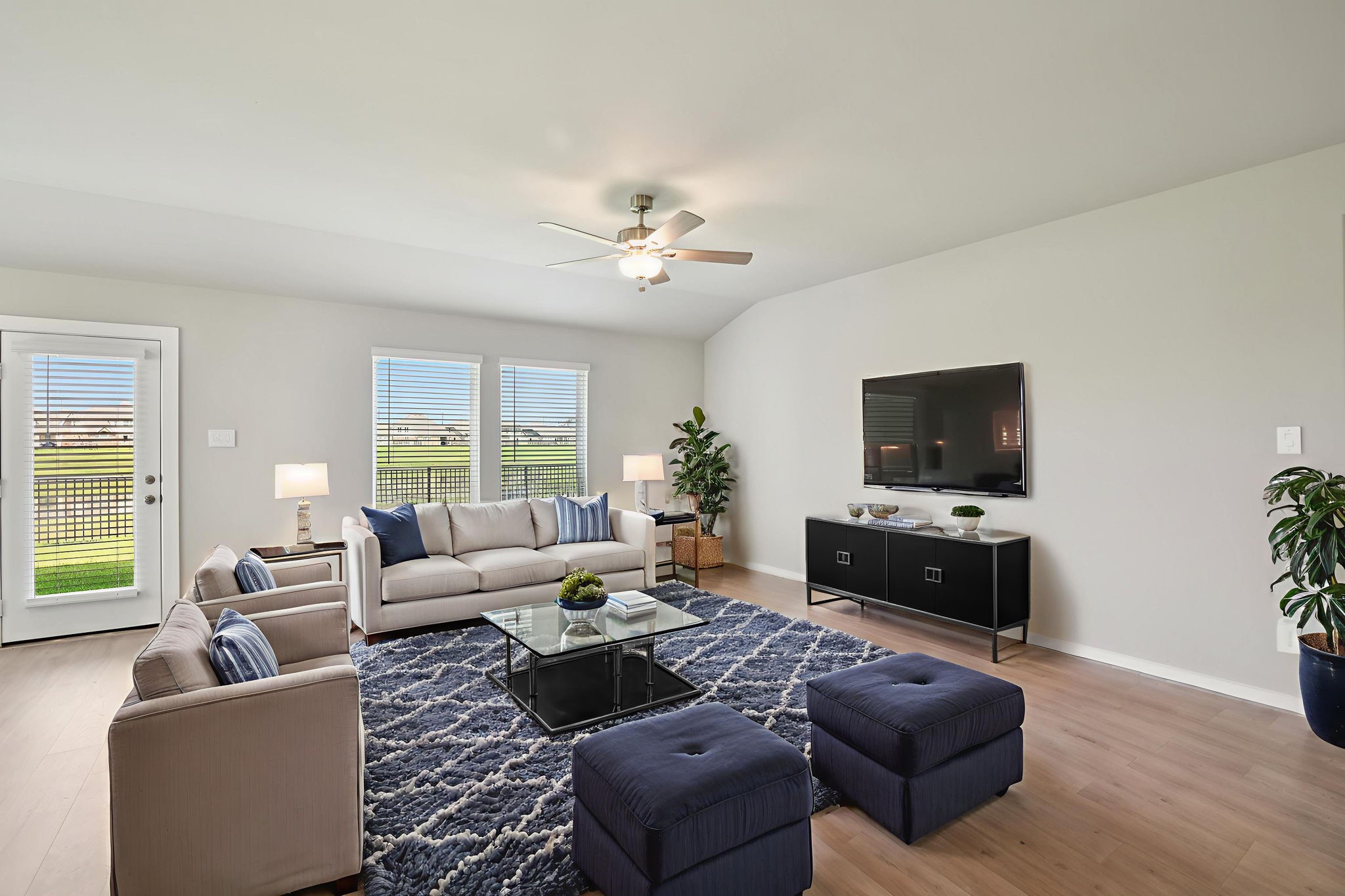 1672 Hopson Ranch Drive Conroe, TX 77301 - Photo 13 of 44 a living room with furniture and a flat screen tv