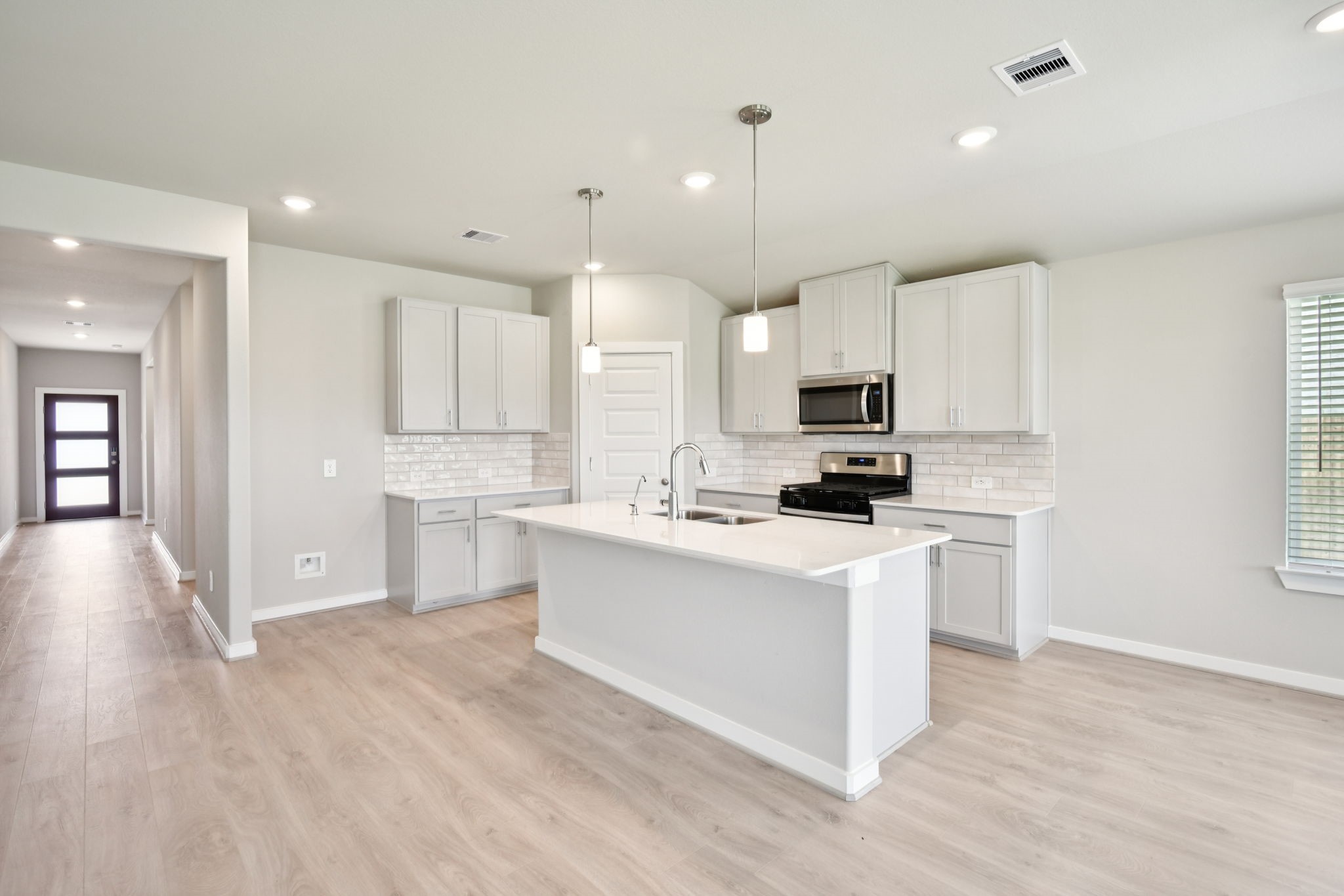 1672 Hopson Ranch Drive Conroe, TX 77301 - Photo 3 of 44 a view of kitchen with stainless steel appliances refrigerator stove microwave and cabinets