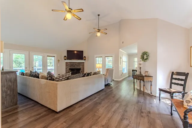 a living room with furniture a fireplace and a flat screen tv