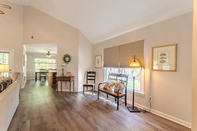 a living room with furniture and a wooden floor