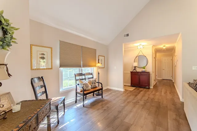a view of a livingroom with furniture and a workspace