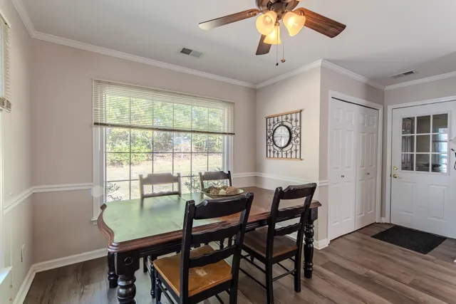 a dining room with furniture and window