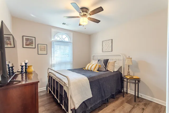 a bedroom with a bed and a chandelier