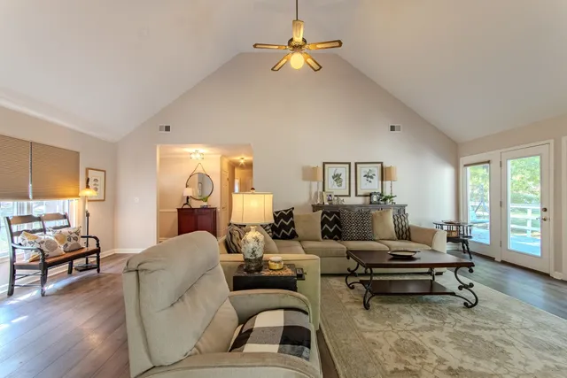 a living room with furniture and a wooden floor
