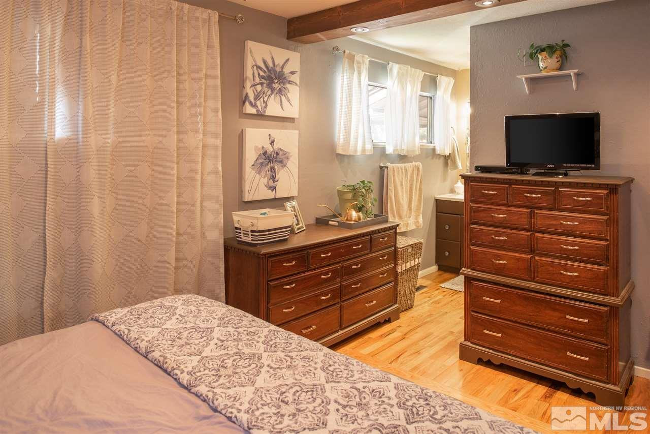 880 Beldon Way Reno, NV 89503 - Photo 9 of 20 a bedroom with a bed and a flat screen tv