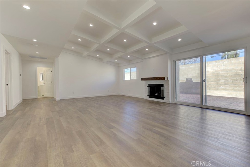 9055 Forbes Avenue Northridge, CA 91343 - Photo 18 of 62 an empty room with wooden floor fireplace and windows